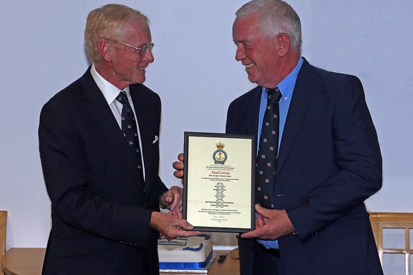 Neal Corran being presented with his RNLI Certificate of Service by Sir Richard Gozney