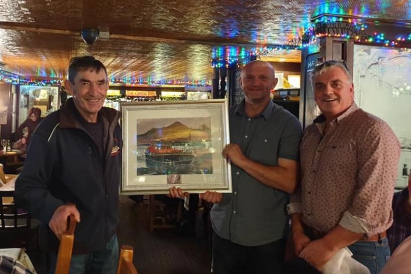 Phillip Simpson being awarded a photo of the 'Ruby Clery' for his service to Peel RNLI.